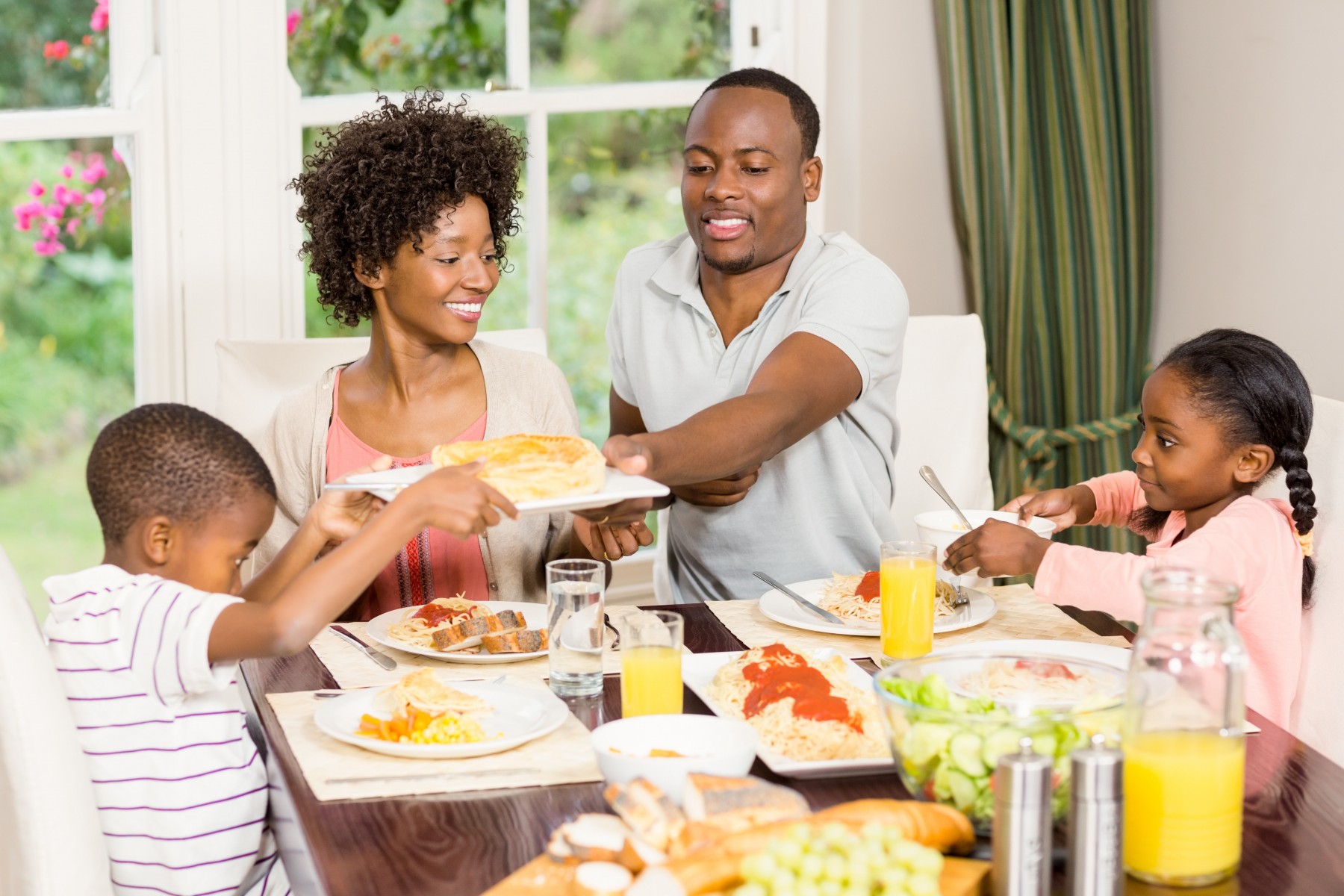 Happy family eating together - Food Ingredient Facts